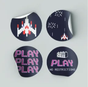 Round stickers with the spaceship, PLAY PLAY PLAY and No Restrictions